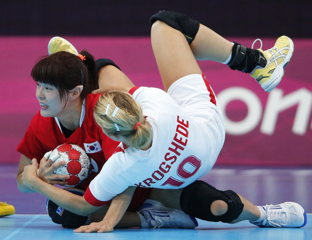 South Korea's Jung Jihae collides with Denmark's Christina Krogshede in their women's handball Preliminaries Group B match at the Copper Box venue during the London 2012 Olympic Games