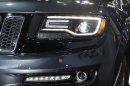 The front lamps on the high-performance SRT version of the 2014 Jeep Grand Cherokee are seen at the North American International Auto Show in Detroit, Tuesday, Jan. 15, 2013. The lamps are tinted black, giving it a distinct look. Ralph Gilles, a Chrysler design leader who also is president and CEO of the SRT brand and motorsports, noted the vehicle has black "kind of like death", headlamps. (AP Photo/Carlos Osorio)