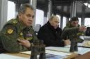 Russia's President Putin, Defence Minister Shoigu and head of Russian army's main department of combat preparation Buvaltsev watch military exercises at Kirillovsky firing ground in Leningrad region