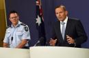 Australia's Prime Minister Tony Abbott (R) and Australian Federal Police deputy commissioner Michael Phelan speaks to the media in Sydney on April 18, 2015, after two men were arrested in Melbourne for allegedly planning an IS-inspired attack