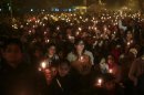 Demonstrators hold candles during a candlelight vigil for a gang rape victim who was assaulted in New Delhi