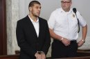 Former New England Patriots NFL football tight end Aaron Hernandez, left, appears at Attleboro District Court on Wednesday, July 24, 2013, in Attleboro, Mass. Hernandez has pleaded not guilty to murder in the death of Odin Lloyd. Hernandez was in court for what was supposed to be a probable cause hearing, but prosecutors said the grand jury is still considering the evidence against him. A judge rescheduled the probable cause hearing for Aug. 22, after considering defense objections to a delay. (AP Photo/Bizuayehu Tesfaye)