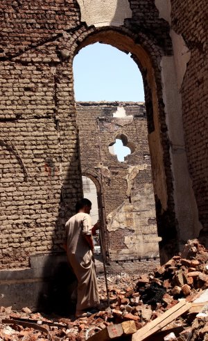 An Egyptian walks in the ruins of the Evangelical Church …