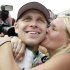 Ed Carpenter gets a kiss from his wife, Heather, after he won won the pole for the Indianapolis 500 auto race, at Indianapolis Motor Speedway in Indianapolis, Saturday, May 18, 2013. Carpenter won the pole with a speed of 228.762 mph. (AP Photo/AJ Mast)