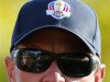 The golf course is reflected in the sunglasses of U.S. captain Love III as he walks along the 11th fairway during the afternoon four-ball round at the 39th Ryder Cup golf matches at the Medinah Country Club