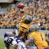 West Virginia quarterback Geno Smith (12) is tackled at the goal line by TCU's Kevin White (25) and Joel Hasley (36) during the first half of their NCAA college football game in Morgantown, W.Va., on Saturday, Nov. 3, 2012. (AP Photo/Christopher Jackson)