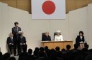Japan's PM Abe delivers a speech as Emperor Akihito and Empress Michiko listen during a ceremony to commemorate the anniversary of Japan's restoration of sovereignty in Tokyo