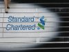 A woman walks down the stairs of the Standard Chartered headquarters in Hong Kong