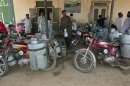 Milkmen gather outside a distribution point in Sahiwal