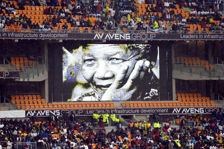 A screen shows South African former president Nelson Mandela during his memorial service at the FNB Stadium (Soccer City) in Johannesburg on December 10, 2013