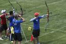 In this photo taken Monday, June 8, 2015, archer Ricardo Soto, 15, right,from Chile, fires down range under the watchful eye of his coach during practice for the World Archery Youth Championships at the National Field Archery Association's Easton Yankton Archery Complex in Yankton, S.D. More than 450 archers representing 51 countries are taking part in the tournament, which runs through Sunday, June 14. (AP Photo/Regina Garcia Cano)