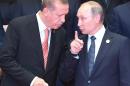 Turkey's President Recep Tayyip Erdogan (L) listens to Russia's President Vladimir Putin (C) during the G20 leaders' family photo in Hangzhou on September 4, 2016