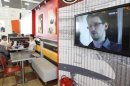 A television screen shows former U.S. spy agency contractor Snowden during a news bulletin at a cafe at Moscow's Sheremetyevo airport