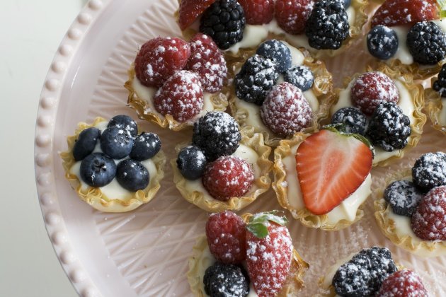 In this image taken on March 4, 2013, creamy lemon-berry tartlets are shown served on a dessert stand in Concord, N.H. (AP Photo/Matthew Mead)