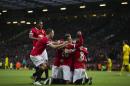 Manchester United's Robin van Persie, lower centre, celebrates with teammates after scoring during the English Premier League soccer match between Manchester United and Liverpool at Old Trafford Stadium, Manchester, England, Sunday Dec. 14, 2014. (AP Photo/Jon Super)