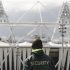 A security guard walks towards the Olympic Stadium in the London 2012 Olympic Park at Stratford in London
