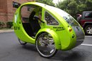 This photo taken July 24, 2013 shows the Organic Transit's ELF bike in a parking lot in Reston, Va. It's the closest thing yet to Fred Flintstone's footmobile _ only with solar panels and a futuristic shape. It's an 