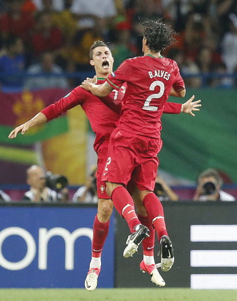 Portugal's Cristiano Ronaldo, left, and Bruno Alves celebrate their second goal during the Euro 2012 soccer championship Group B match between Portugal and the Netherlands in Kharkiv, Ukraine, Sunday, June 17, 2012. (AP Photo/Matthias Schrader)