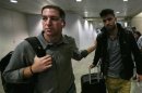 File photo of U.S. journalist Greenwald walking with his partner Miranda in Rio de Janeiro's International Airport