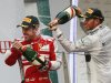 Ferrari driver Fernando Alonso, left, of Spain is sprayed with champagne by second placed Mercedes driver Lewis Hamilton of Britain after winning the Chinese Formula One Grand Prix in Shanghai, China, Sunday, April 14, 2013. (AP Photo/Eugene Hoshiko)