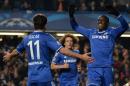 Chelsea's French-born Senegalese striker Demba Ba (R) celebrates with teammate Brazilian midfielder Oscar (L) after scoring the opening goal at Stamford Bridge on December 11, 2013