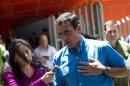 Venezuela's opposition presidential candidate Henrique Capriles talks to the media as he leaves from a news conference in Caracas