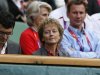 Swiss President Widmer-Schlumpf awaits the start of the men's singles tennis gold medal match between Britain's Murray and Switzerland's Federer at the All England Lawn Tennis Club during the London 2012 Olympic Games