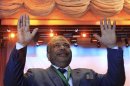 Saad al-Katatni gestures after winning majority of votes by members of the Muslim Brotherhood's Freedom and Justice Party, to be elected as their new leader in Cairo
