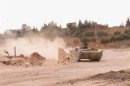 A Syrian army tank is seen in the Khan al-Assal area after clashes between Free Syrian Army fighters and forces loyal to Syria's President Bashar al-Assad, near Aleppo city