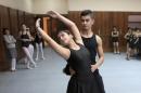 In this Nov. 12, 2014, photo, students practice at the dancing studio at the Baghdad School of Music and Ballet in Monsur district in Baghdad. The school has managed to survive decades of turmoil, a feat that speaks to the resilience of Baghdad's residents through war after war. (AP Photo/Khalid Mohammed)