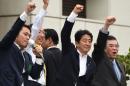 Japanese Prime Minister Shinzo Abe (2nd R) raises his fist as he campaigns in Tokyo on July 9, 2016