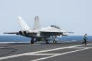 In this picture downloaded from the US Navy website and taken on September 23, 2013, an F/A-18F Super Hornet lands aboard the aircraft carrier USS George H.W. Bush (CVN 77) after conducting strike missions against Islamic State (IS) group targets