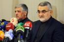 In this photo released by the Syrian official news agency SANA, Alaeddin Boroujerdi, the Iranian head of an influential parliamentary committee on national security and foreign policy, left, speaks during a press conference, Damascus, Syria, Thursday, Oct. 15, 2015. Boroujerdi reiterated his country's full support for the Syrian government, stressing that a political solution is the only way for Syria to emerge from the current crisis. Boroujerdi's comments came a day after a regional official said hundreds of Iranian troops are being deployed in northern and central Syria, dramatically escalating Tehran's involvement in the civil war as they join allied Hezbollah fighters in an ambitious offensive to wrest key areas from rebels amid Russian airstrikes. (SANA via AP)