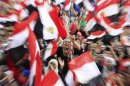 Protesters against ousted President Mursi wave Egyptian flags in Tahrir Square in Cairo