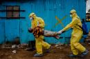 This Sept. 5, 2014, photo by New York Times photographer Daniel Berehulak, part of a winning series, shows James Dorbor, 8, suspected of being infected with Ebola, being carried by medical staff to an Ebola treatment center in Monrovia, Liberia. The boy, who was brought in by his father, lay outside the center for at least six hours before being seen. Berehulak is the winner of the 2015 Pulitzer Prize for Feature Photography, announced Monday, April 20, 2015, at Columbia University in New York. (Daniel Berehulak, New York Times, Columbia University via AP)