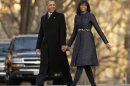 U.S. President Barack Obama and First Lady Michelle Obama walk from the White House to the Inaugural Parade reviewing stand in Washington
