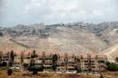 Houses are seen in the West Bank Jewish settlement of Maale Adumim as the Palestinian village of Al-Eizariya is seen in the background
