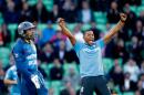 England bowler Chris Jordan celebrates taking the wicket of Sri Lanka's Tillakaratne Dilshan, left, who was caught out by Harry Gurney during the One Day cricket match between England and Sri Lanka at the Oval cricket ground in London, Thursday, May 22, 2014. (AP Photo/Matt Dunham)
