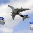 Boeing flags flutter as an Airbus A380, the world's largest jetliner, takes part in a flying display during the 49th Paris Air Show at the Le Bourget airport near Paris