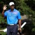 Tiger Woods of the U.S. acknowledges the crowd as he leaves the tenth green during round one of the BMW Championship golf tournament in Carmel