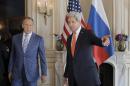 U.S. Secretary of State John Kerry, right, greets his Russian counterpart, Sergey Lavrov, prior to their meeting in Paris, France, Thursday, June 5, 2014. Diplomatic efforts to resolve the months-long standoff between Ukraine and Russia kicked into high gear in two European capitals on Thursday. (AP Photo/Laurent Cipriani, pool)