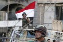 Security personnel watch over supporters of former Egyptian President Mursi during clashes outside the Republican Guard building in Cairo