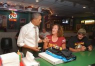 US President Barack Obama pays for a pizza at Bob Roe's Point After bar in Sioux City, Iowa, on September 1. Obama and his Republican challenger Mitt Romney derided each other's record on job creation as they made a fresh push through key battleground states