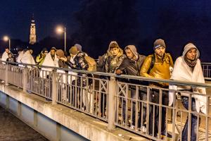 In this Oct. 25, 2015 picture migrants cross a bridge&nbsp;&hellip;