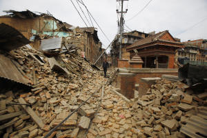 A Nepalese man walks through destruction caused by &hellip;