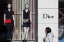 A woman walks past a Dior shop in downtown Brussels