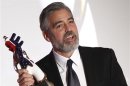 U.S. actor Clooney reacts with the German Media Award 2012 after he was honoured during a ceremony in Baden Baden