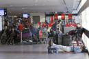 Passengers rest and wait for their flights at the departure area inside the international airport of Santiago
