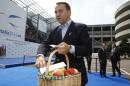 Polish Foreign Minister Radoslaw Tomasz Sikorski arrives holding a basket of apples to protest against Russia's ban on food imports, during an informal meeting of the EU Foreign Affairs Ministers, in Milan, Italy, Friday, Aug. 29, 2014. European Union foreign ministers on Friday were set to weigh adopting a tougher stance on the Ukraine crisis amid increasing calls to beef up economic sanctions against Russia. (AP Photo/Luca Bruno)