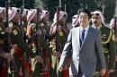 Japanese Prime Minister Shinzo Abe reviews the honor guard upon his arrival at the Royal Palace before a meeting with Jordan's King Abdullah II on January 18, 2015 in Amman, part of a tour of the Middle East